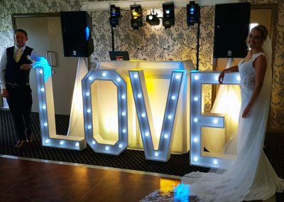 Love letters by DJ Booth with bride and groom